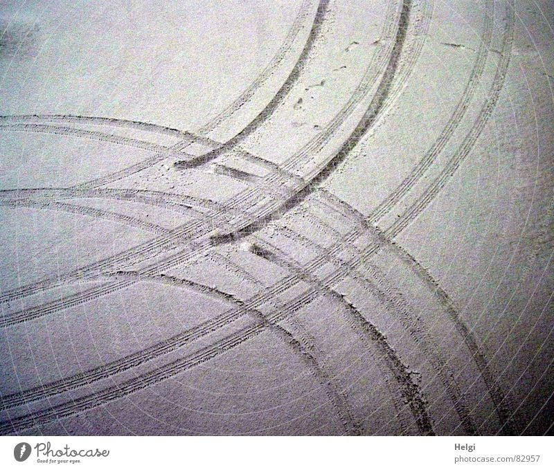Tire tracks in the snow from a bird's eye view Colour photo Subdued colour Exterior shot Detail Pattern Deserted Twilight Shadow Bird's-eye view Winter Snow Ice