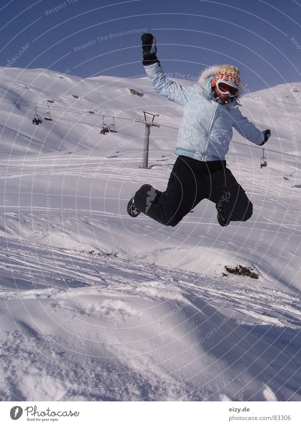 jump Woman Style Austria Joy Winter sports Mountain Snow Ski run To enjoy Jump Skiing goggles Joke Posture Ski lift Chair lift Tall Snowboarder
