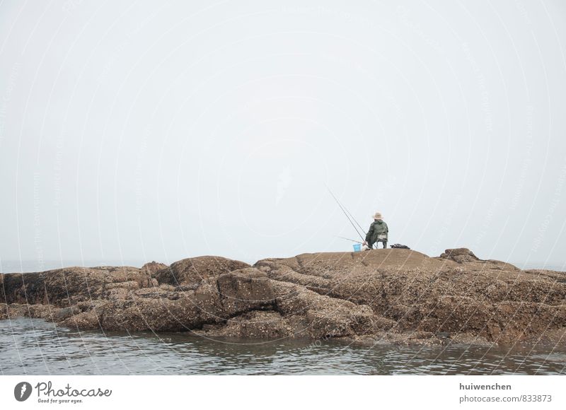 the fisherman, alone Human being Masculine Man Adults 1 45 - 60 years Nature Water Fog Coast Ocean Lake Stone Sit Serene Calm Fishing (Angle) Colour photo