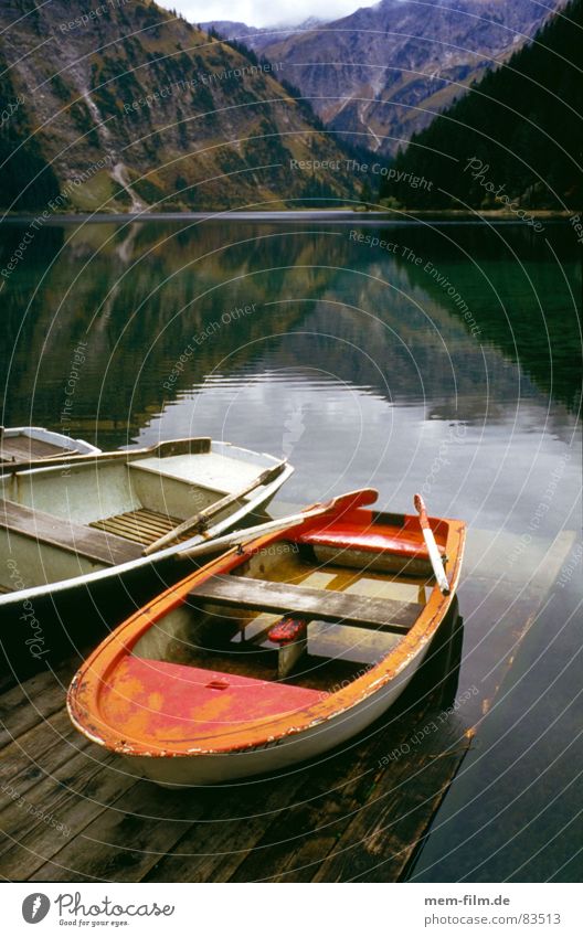 mountain lake Lake Rowboat Mountain lake Red Watercraft Relaxation Navigation clear water Alps Nature Contrast postcard motif