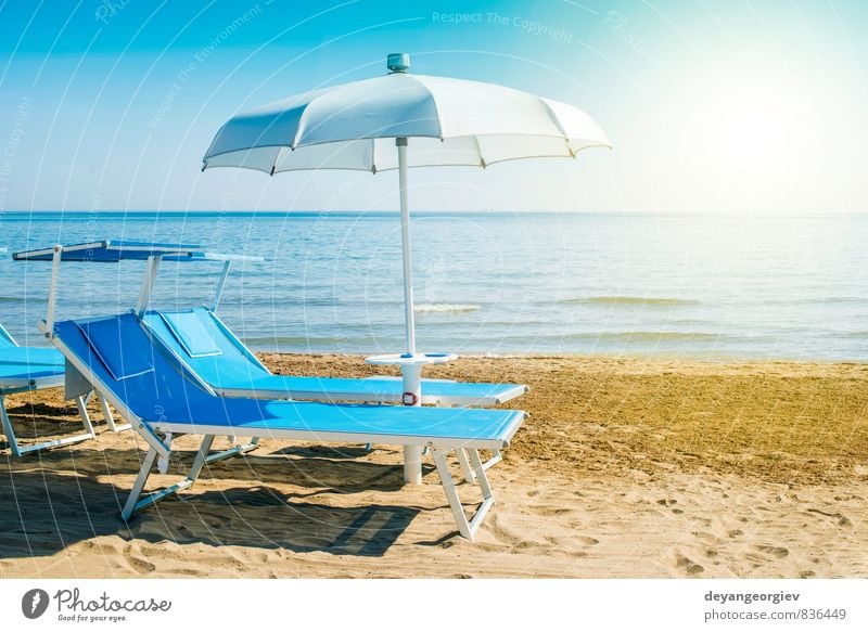 Blue sunbeds and umbrellas on the beach Luxury Beautiful Relaxation Leisure and hobbies Vacation & Travel Tourism Summer Sun Beach Ocean Island Chair Nature