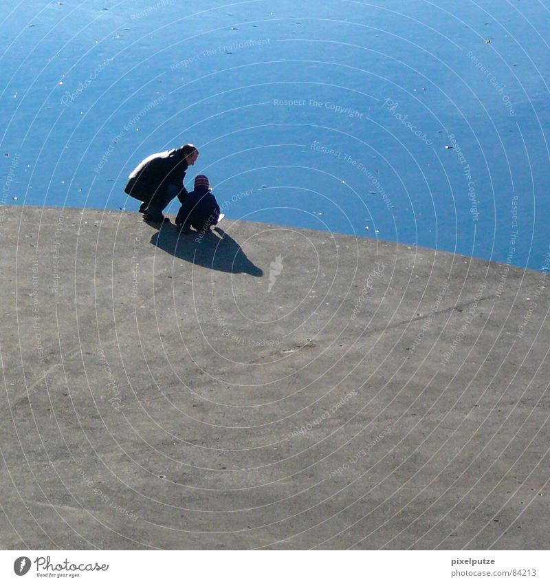 Ice-cold games ||| Lake Ice-cream vender Thorough Splashing Concrete Hard Round Platform Father Daughter Child Stand Shadow Curved Delicious Ice floe