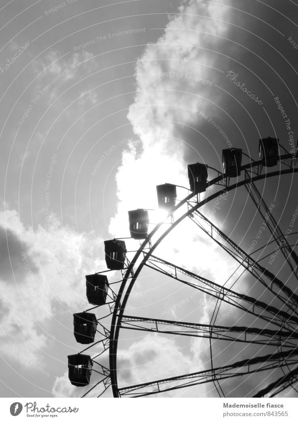 Ferris wheel against the light Leisure and hobbies Fairs & Carnivals Clouds Storm clouds Sunlight Summer Threat Dark Large Tall Above Gray Black White
