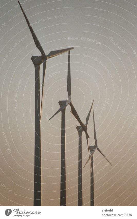 Wind power in the evening light Wind energy plant Industry windmills Energy industry renewable energy sources Renewable energy