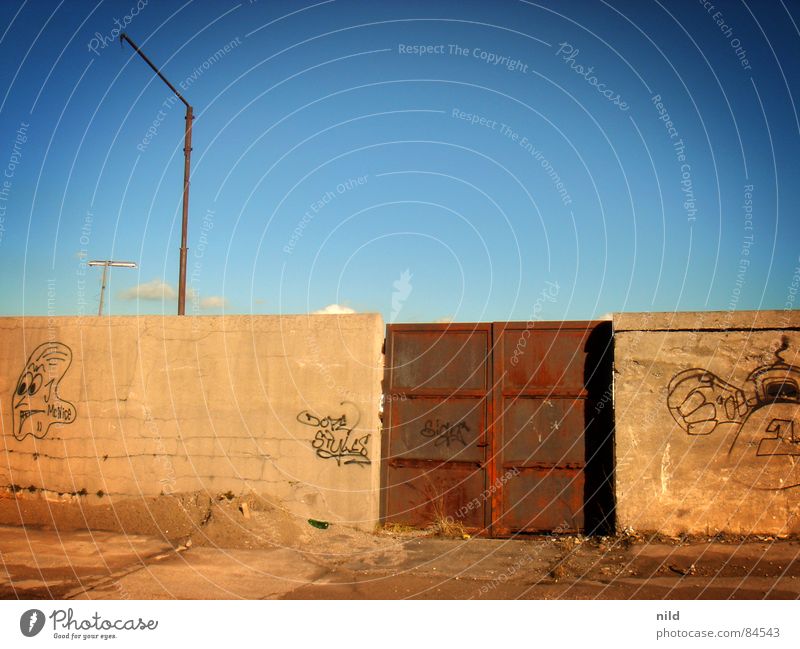 Rusty gate Daub Highway ramp (entrance) Iron Heavy Mysterious Gray Yellow Brown Freight station Munich Derelict Descend Passage Access Portal Boredom Graffiti