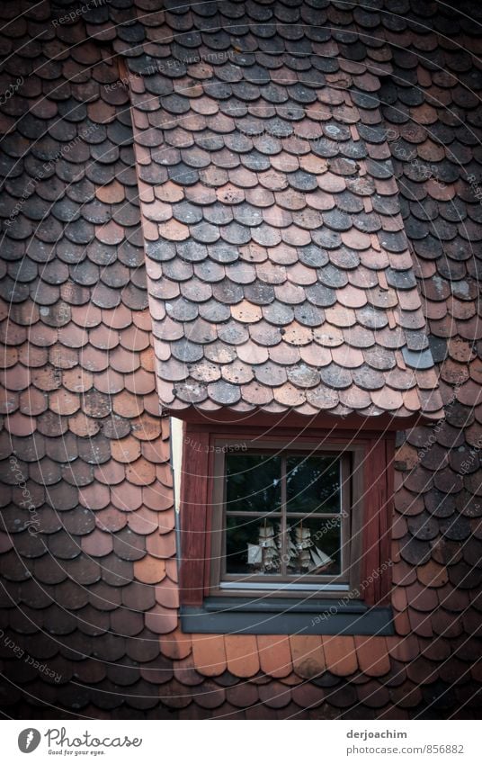 A sailing ship behind an old skylight. A sailing ship behind a roof window. Rothenburg ob der Tauber. " Franconia " / Bavaria Calm Living or residing