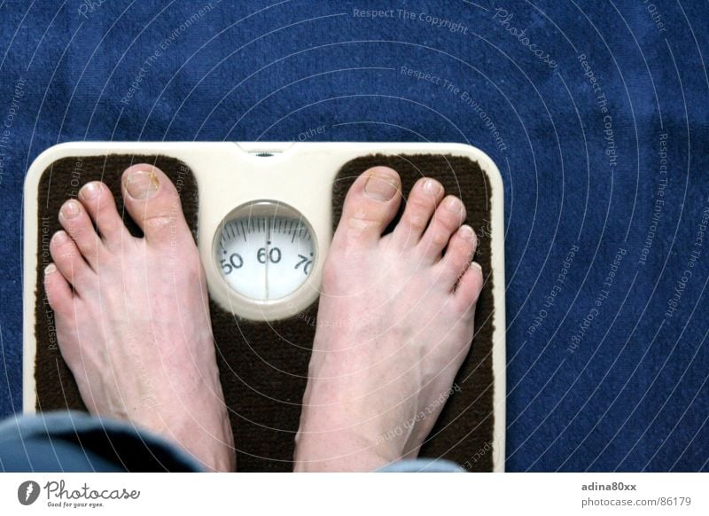 Top view of feet on weighing scale. Women weigh on a weight