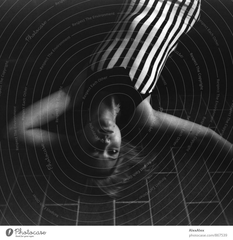 black and white analogue portrait of a young woman in a striped dress looking overhead into the camera Feasts & Celebrations Flirt Young woman