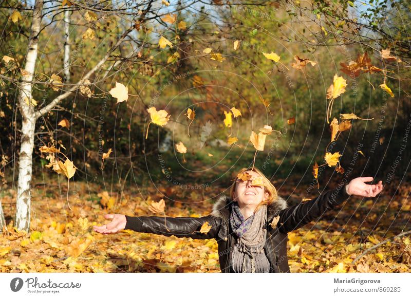 Young woman enjoying falling autumn leaves in park Lifestyle Elegant Joy Beautiful Healthy Leisure and hobbies Garden Human being Youth (Young adults) Woman