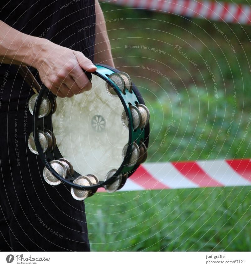 Outside the restricted zone Pandeiro Tambourine Exclusion zone Closed Striped Red Hand Sound Percussion instrument Concert Calm Grass Rhythm Musical instrument