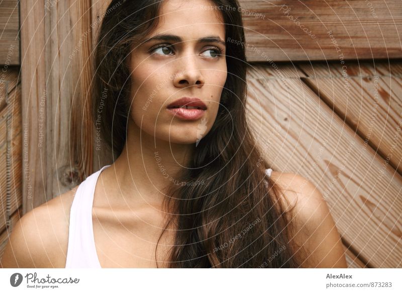 Portrait of a young beautiful slim woman with dimples in front of a wooden door Young woman Youth (Young adults) Face 18 - 30 years Adults Undershirt Brunette