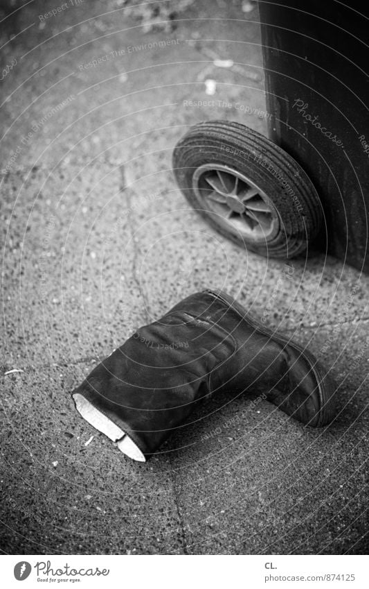 boots, garbage can Footwear Boots Trash container Ground Dirty Broken Environmental pollution Throw away Inattentive Black & white photo Exterior shot Deserted