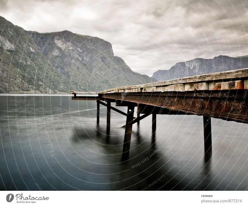 footbridge Clouds Hill Rock Coast Bay Fjord Ocean Dark Footbridge Jetty Norway Mysterious Calm Colour photo Exterior shot Deserted Copy Space left