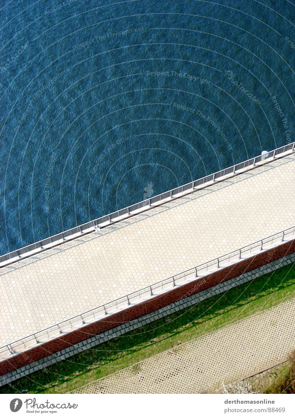 Caribbean dyke Dike Wall (barrier) Pave Meadow Grass Barrier Ocean Lake Waves Undulating Wind Jump Green Red Contrast Across Bird's-eye view Exterior shot Tide