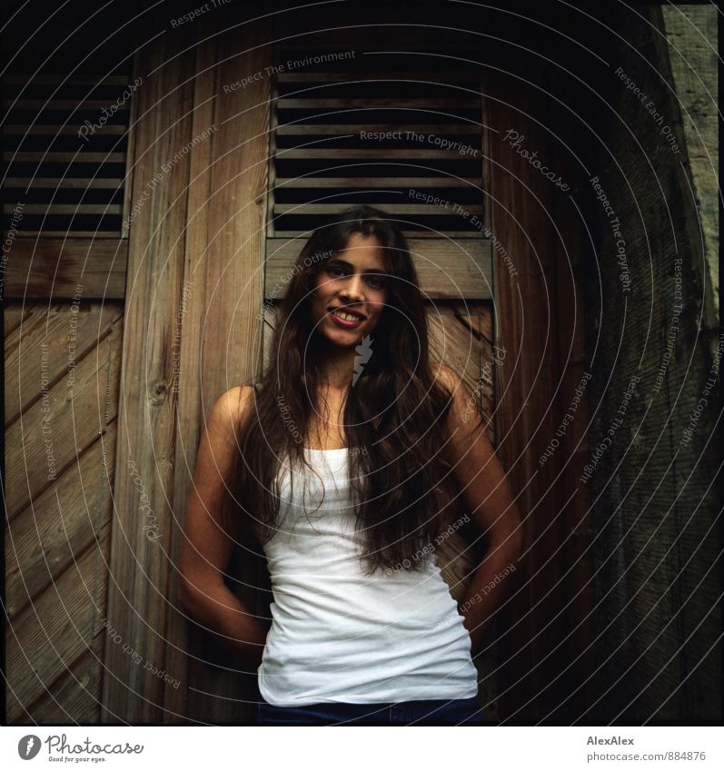 analogue portrait of a young, longhaired, beautiful woman in front of a wooden door Young woman Youth (Young adults) 18 - 30 years Adults Wooden door
