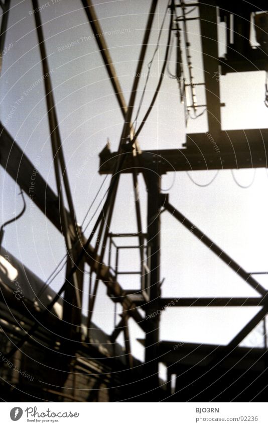 steelwork Steel Dark Shadow Derelict Crane Lifting device Ruin Shut down Remote Iron Metal Industrial Photography Analog Vertical Portrait format Black Gray