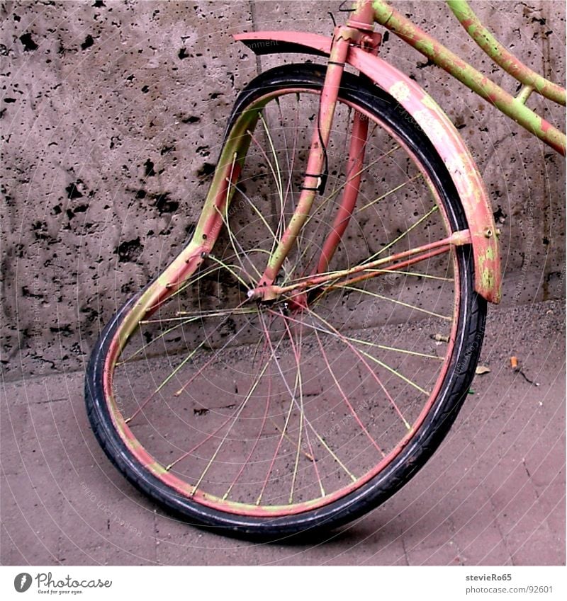 Bicycle in Amsterdam Scrap metal Pink Detail Traffic infrastructure Spokes Old Bruised