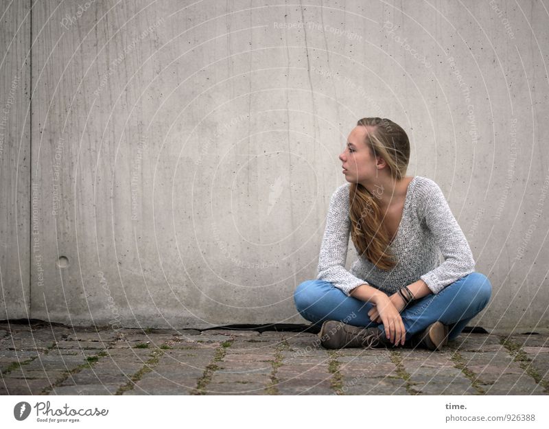 . Feminine Young woman Youth (Young adults) 1 Human being Wall (barrier) Wall (building) Lanes & trails Paving stone Jeans Sweater Blonde Long-haired Observe