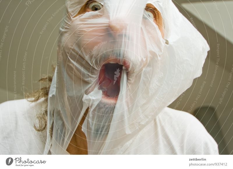 Scream of horror. Screaming ghost face. Scary halloween mask. Shot with  long exposure. Stock Photo
