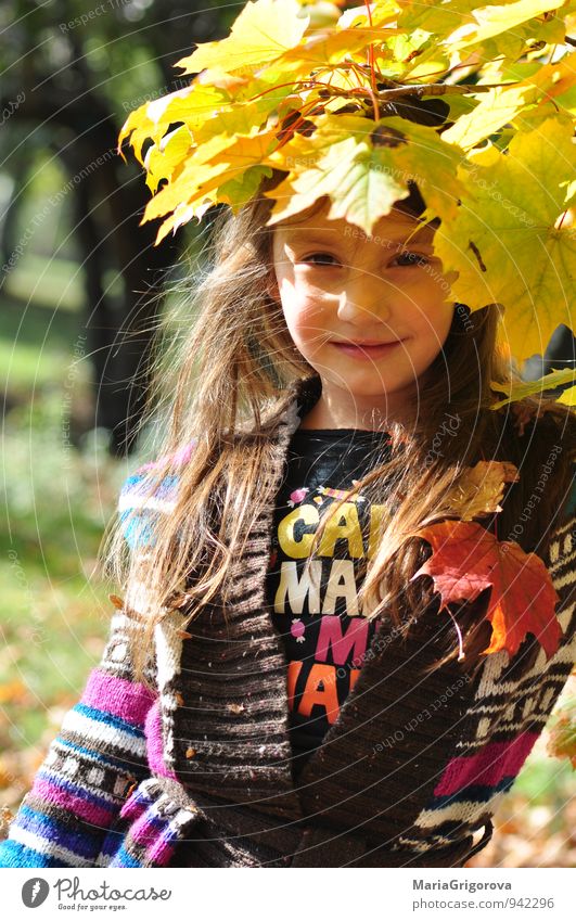 Beautiful girl enjoying autumn leaves in park Lifestyle Healthy Trip Garden Human being Child Girl Hair and hairstyles Face 1 3 - 8 years Infancy Nature Autumn