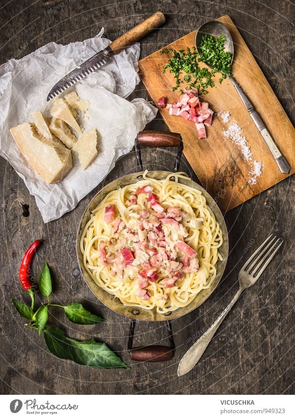 Spaghetti Carbonara in old pot with parmesan and herbs. Food Meat Cheese Vegetable Herbs and spices Nutrition Lunch Dinner Buffet Brunch Organic produce Diet