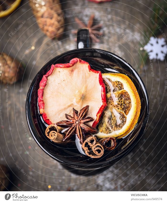 Cup of mulled wine on dark wood with snow. Food Fruit Herbs and spices Beverage Hot drink Tea Alcoholic drinks Wine Mulled wine Design Winter Christmas & Advent