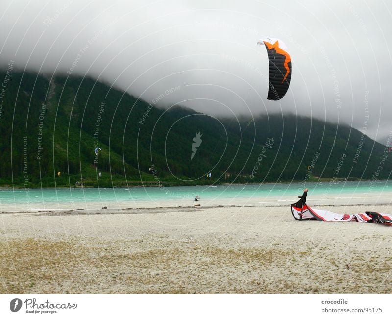kitesurfing in austria Kiter Surfer Lake Lake Achensee Federal State of Tyrol Cold Wind Clouds Passion Dark Beach String Forest Sports Dangerous Man
