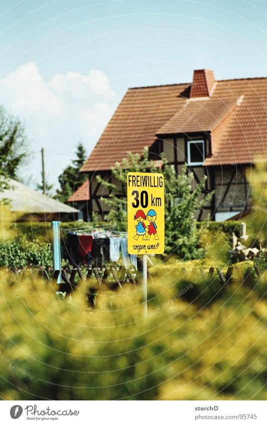Village idyll Transport Traffic infrastructure Signs and labeling Human being 30 km/h Blue sky Respect Street Idyll of one's own free will