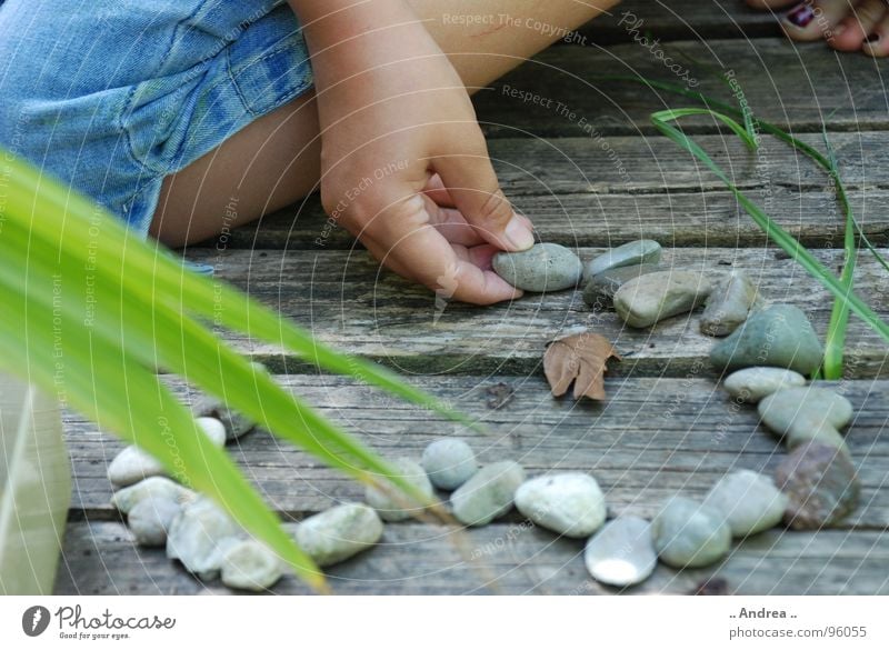 Heart of stone Wellness Harmonious Well-being Contentment Relaxation Calm Meditation Playing Summer Garden Child Girl Young woman Youth (Young adults) Arm Hand