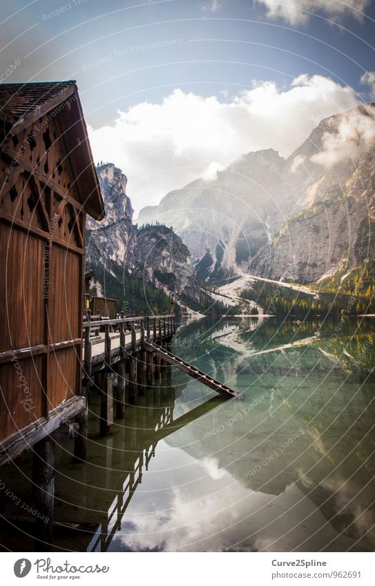 mirror image Nature Elements Water Sky Clouds Beautiful weather Mountain Peak Lakeside Authentic Dolomites Pragser Wildsee Lake Wood Wooden house Wooden hut Hut