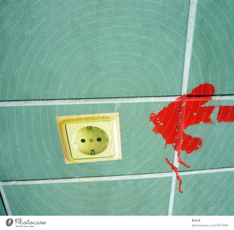 Power socket on turquoise tiles with red arrow. Indication for high electricity cost & expensive energy. Save electricity with green power in energy crisis. Switch to innovative green renewable eco friendly energy to protect environment. Old socket without plug.
