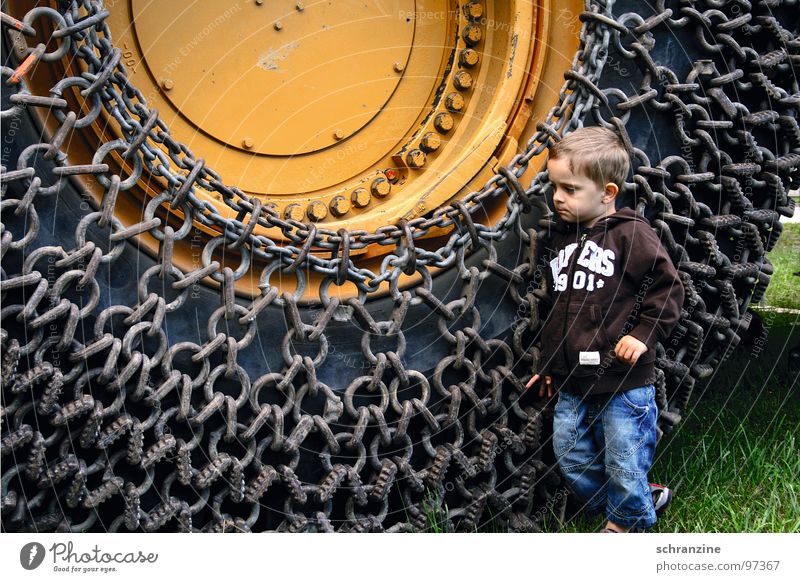 boy and machine Boy (child) Toddler Child Machinery Tire Construction site Think Large Small Might Discover Truck Industry Human being Chain ponder driven trax