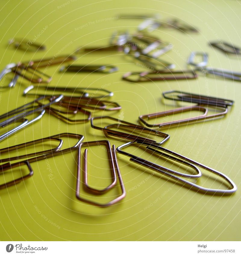 many paperclips on yellow background Paper clip Holder Staple Wire Tack Curved Brown Small Subsoil Yellow Flat Helper Work and employment Store premises
