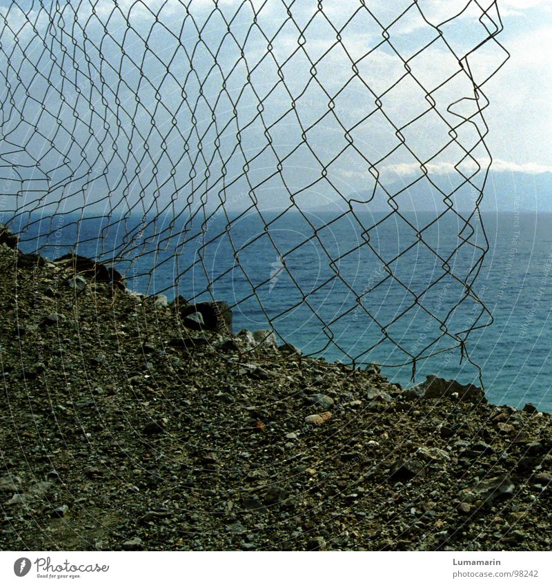 limitations Border Fence Wire netting Coast Gravel Ocean Lake Calm Reach Accessible Far-off places Near Horizon Clouds Spacing Gap Empty Passage Barrier Broken