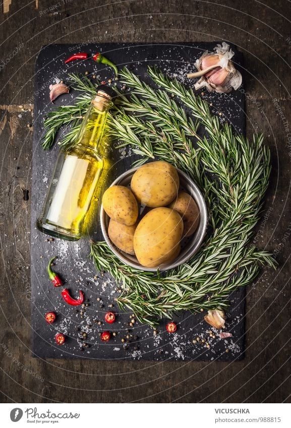 Potatoes with rosemary, spices and a bottle of oil. Food Vegetable Herbs and spices Cooking oil Nutrition Lunch Organic produce Vegetarian diet Diet Beverage