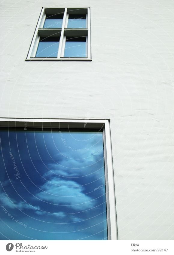 A white house wall with windows in which the blue sky is reflected with clouds Window reflection Clouds Sky House (Residential Structure) Facade outlook Future